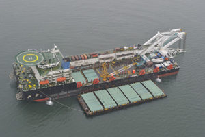 The cargo ship with the crane, the top view. Pipelaying barge.